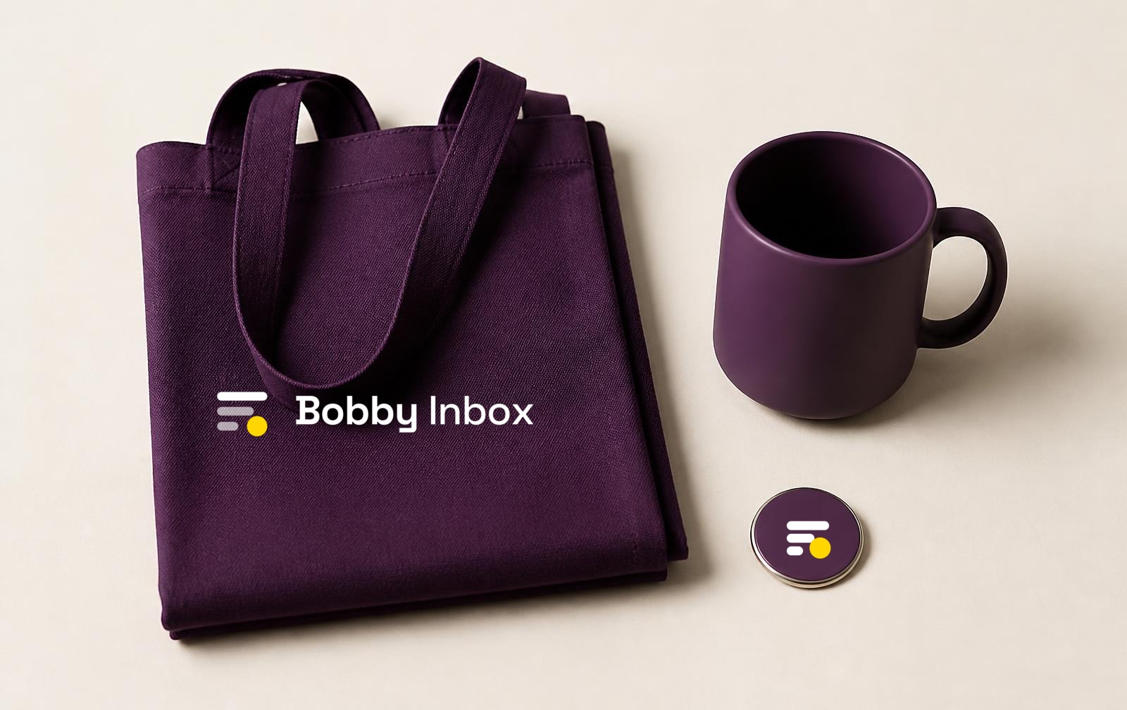 Bobby Inbox merchandise flat lay with the Signal Stack lockup applied to a tote and notebook